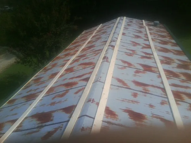 Rusted metal roof panels with new wood purlins before replacement — Storm Damage Roof Repair in Torrance by Roofing Brothers